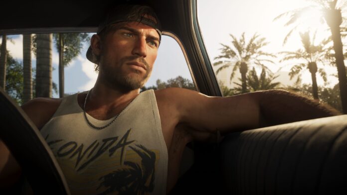 Jason_Duval_02 A screenshot from GTA VI with a man in a white wife-beater seating in a car.