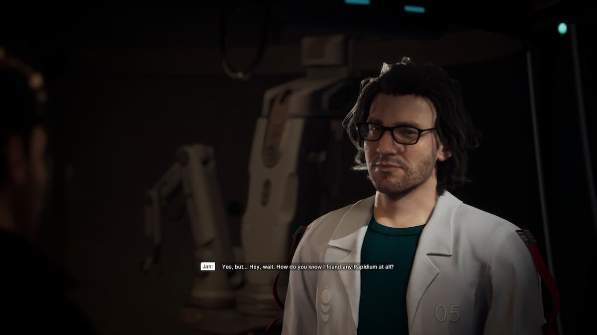 A man with longer hair in glasses and a white coat.