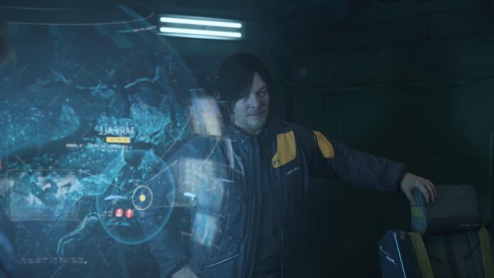death stranding 2 sam magellan A man wearing a jacket standing in front of a hologram.