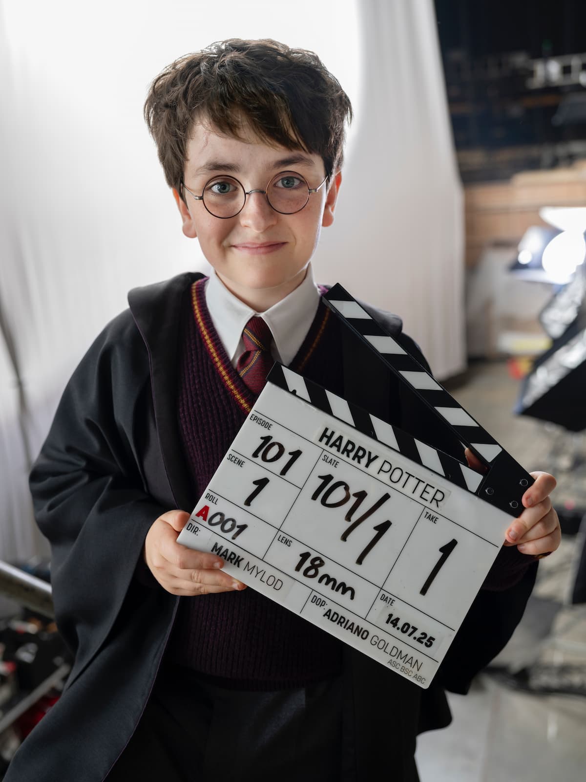 A boy with dark hair and glasses.