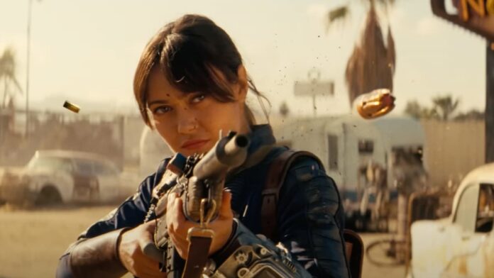 fallout season 2 trailer A woman in a blue suit holding a gun. Image from the Fallout Season 2 trailer.