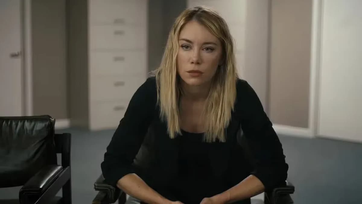 A blonde woman sitting in an office chair.
