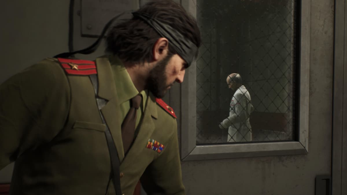 A man in a military uniform looking through the window of a door.