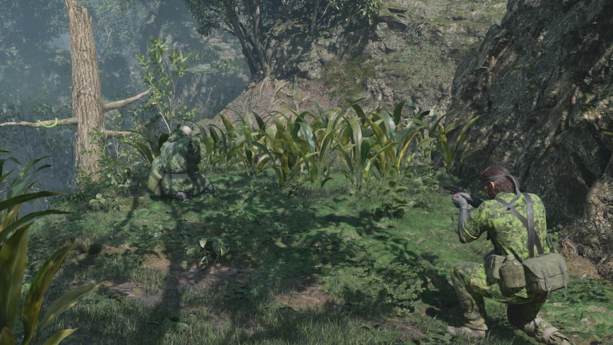 A man in green sneaking up on a man in the grass.