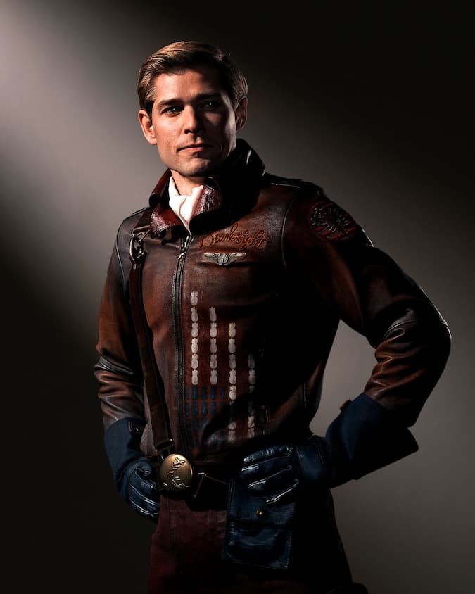 A man in a brown bomber suit.