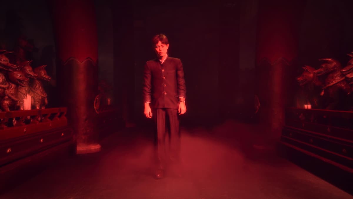 A boy bathed in red light in one of the Silent Hill f endings.