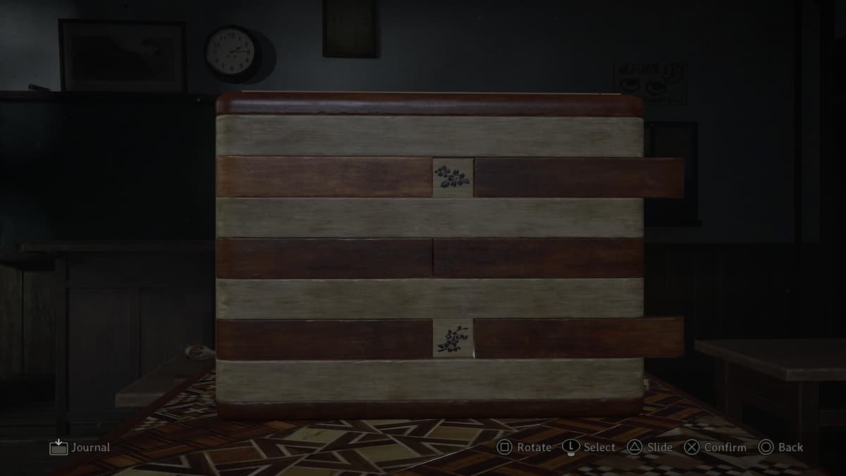 A wooden box showing sakura flower patterns as one of the Silent Hill f puzzle solutions.