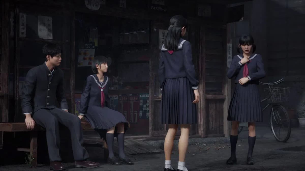 Four high schoolers sitting and standing together.