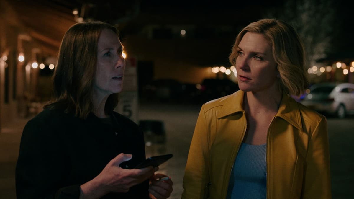 A blonde woman talking to a dark-haired woman in Pluribus.