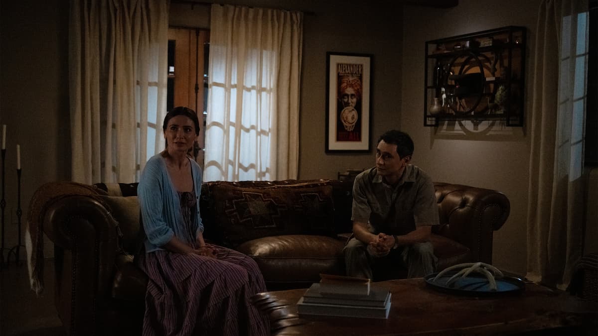 A man and woman sitting on a couch.