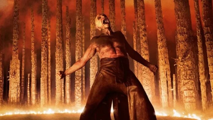 bone temple fire scene A bald man with his arms outstretched. Cover image for our story on 28 Years Later: The Bone Temple's soundtrack.