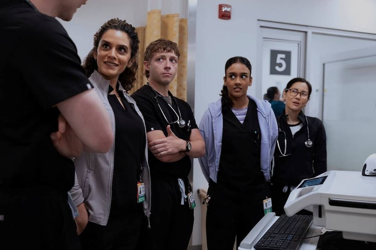 Four doctors looking at a fifth doctor in The Pitt.