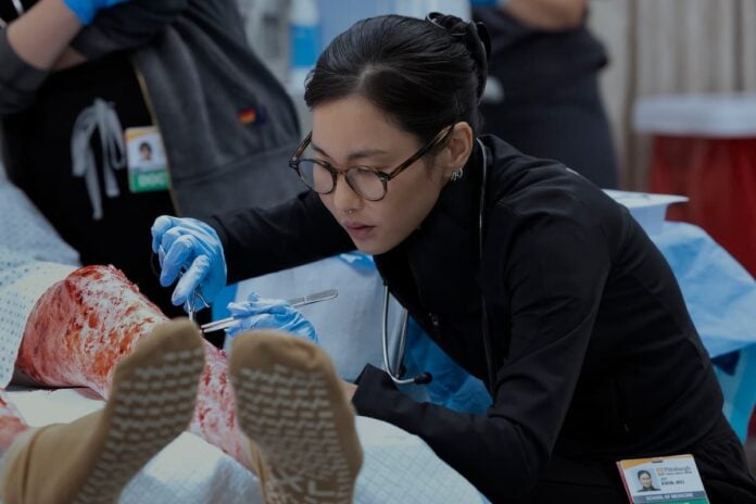 irene-choi (1) A lady with glasses operating on a patient.
