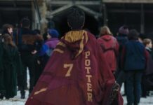 Like It or Not, Harry Potter Is About to Be a Massive Cultural Touchstone Yet Again A boy in a red cloak that says Potter. Cover image for our Harry Potter op-ed.