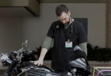 Burnout Is the Name of the Game in The Pitt Season 2 A man touching a motorcycle in The Pitt Season 2.