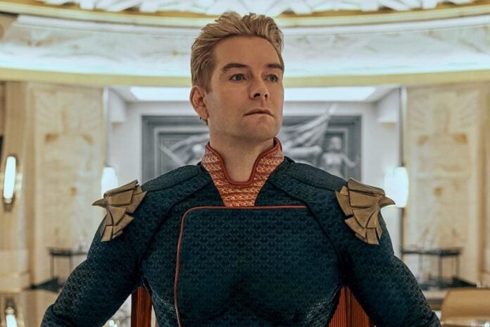homelander pose (1) A blonde man in a superhero outfit.