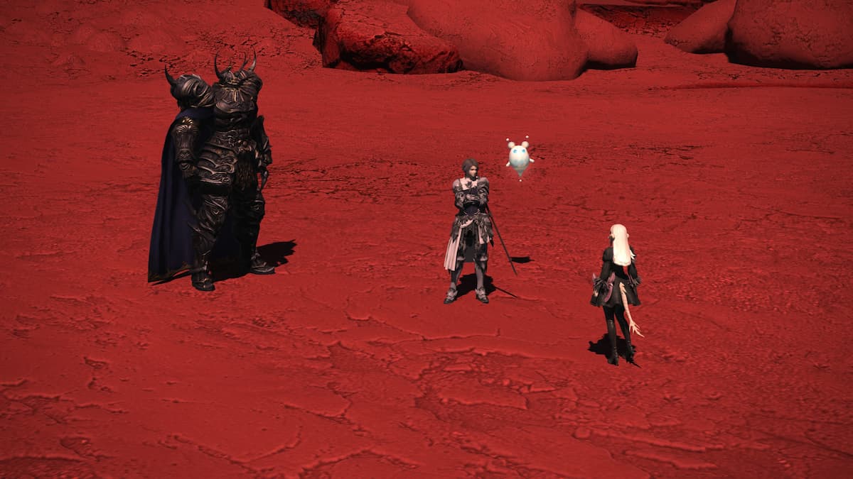 Three figures talking on the red surface of the moon.