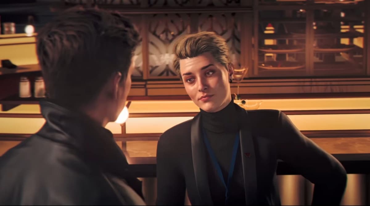 A man talking to a woman at a bar.
