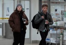 I’m Ready to Defend My Queen Santos Once Again in The Pitt Season 3 A woman in man walking into a hospital in The Pitt Season 3